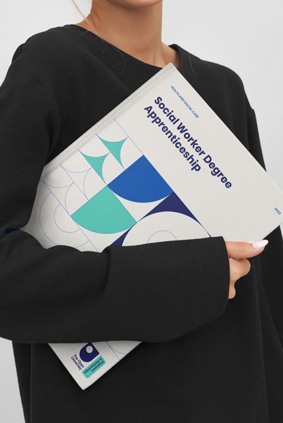 Lady holding a booklet from The Open University